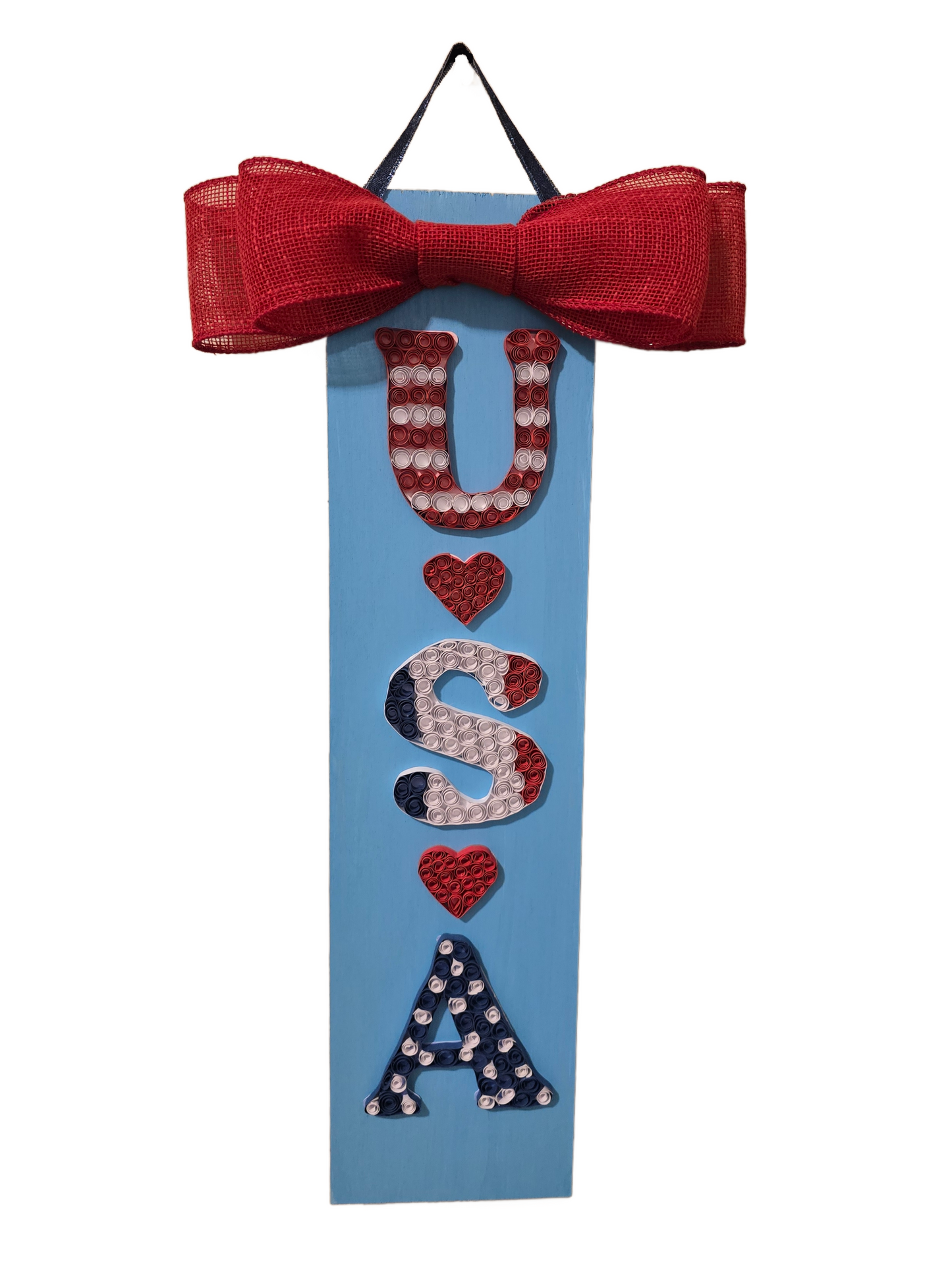 Decorative sign with 'USA' text and red bow on a white background